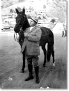 William Wrigley, Jr. holding a horse, c. 1919