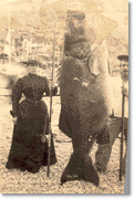 Mrs. A.W. (Pauline) Barrett and boatman Jim Gardner with the black sea bass she had caught, 1901