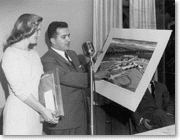 Angelo M. Iacoboni holding the plan for the new civic center, c. 1960
