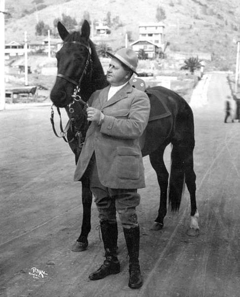 William Wrigley, Jr. holding a horse, c. 1919